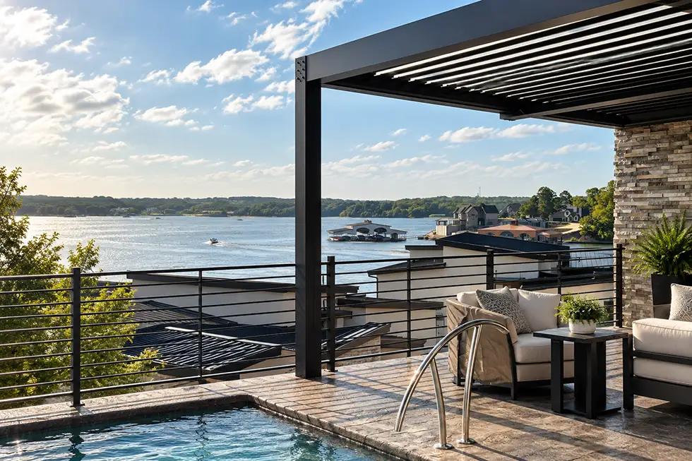 Black louvered pergola shading a lakefront patio and pool overlooking the Lake of the Ozarks