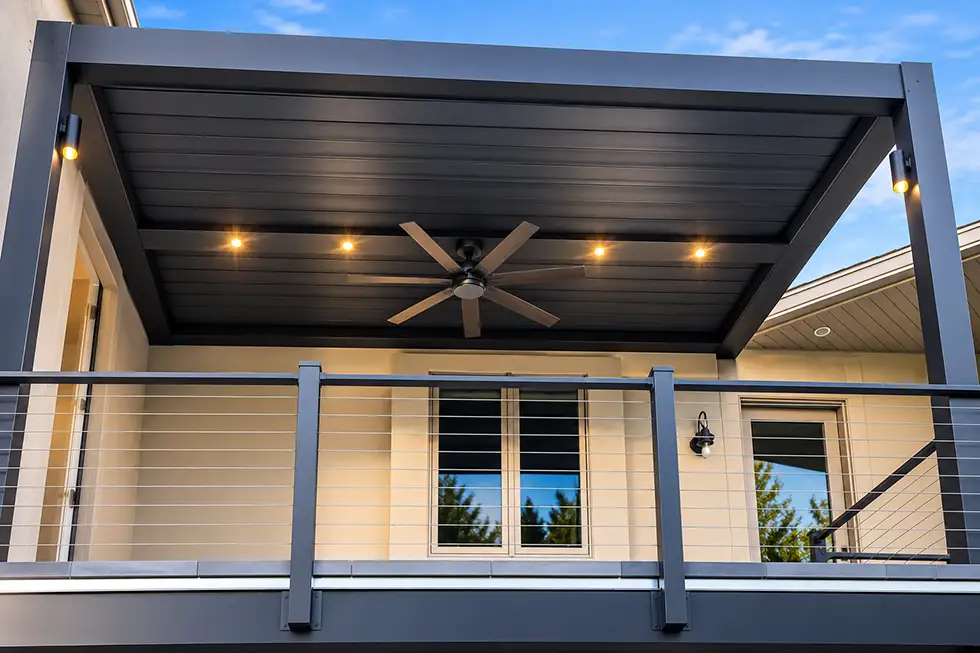 Motorized louvered pergola with integrated recessed lighting and ceiling fan over a residential patio